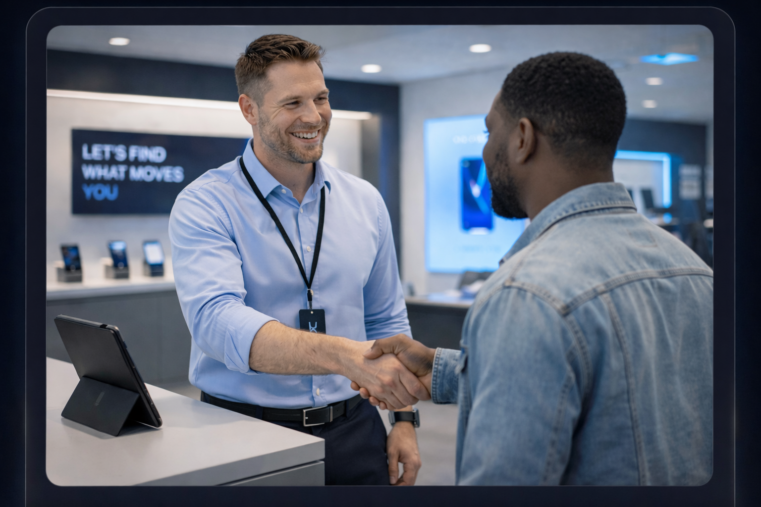 A retail associate greeting a customer with a handshake inside a modern store.
